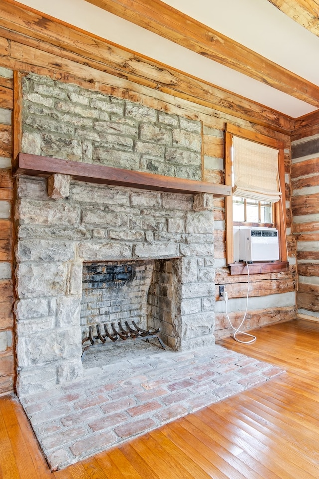 room details with cooling unit, beamed ceiling, and hardwood / wood-style flooring