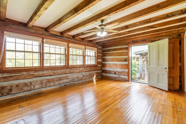 unfurnished room with ceiling fan, light hardwood / wood-style flooring, and beamed ceiling