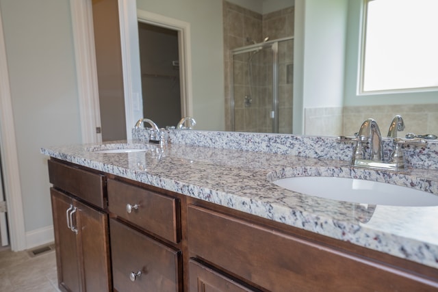 bathroom featuring vanity and a shower with shower door