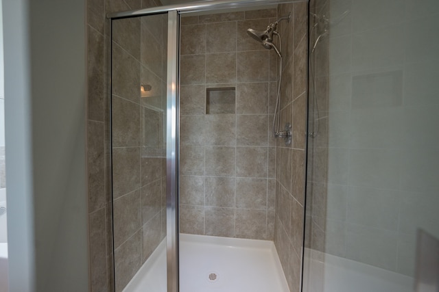 bathroom featuring a shower with shower door