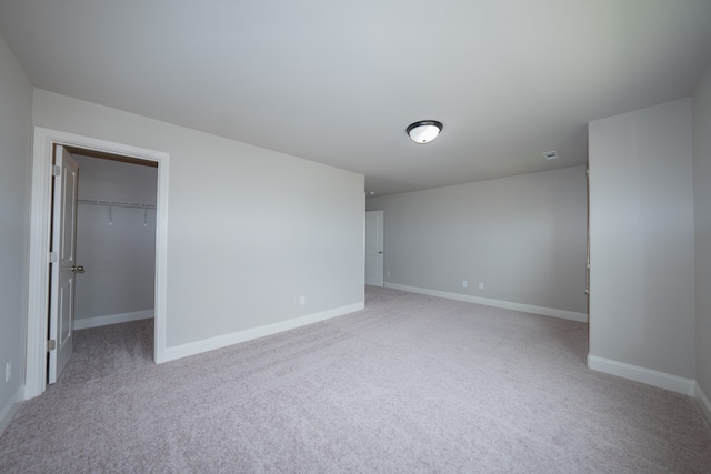 spare room featuring light colored carpet