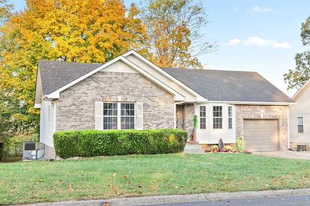 view of front of property with a front yard and a garage