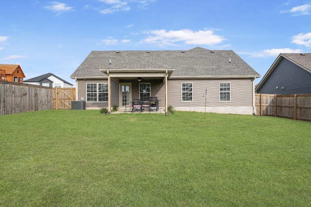 rear view of house with a yard, ceiling fan, and a patio area