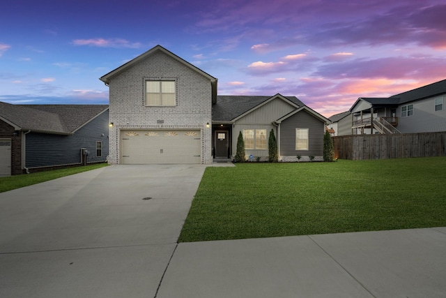 view of front of house with a yard and a garage