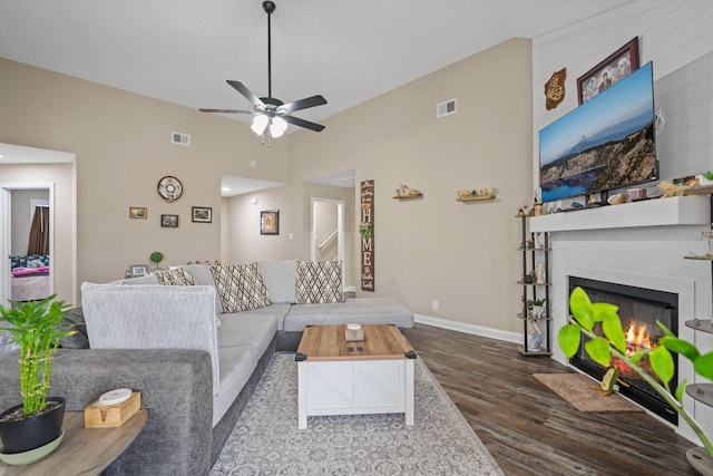 living room with ceiling fan and dark hardwood / wood-style flooring