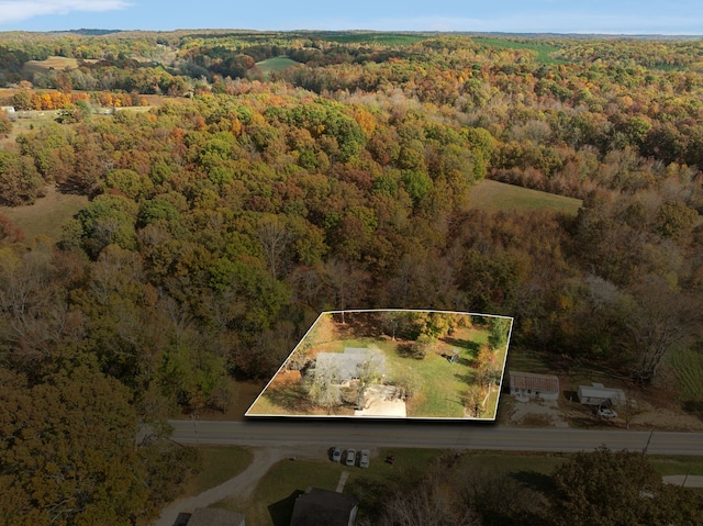 birds eye view of property with a view of trees