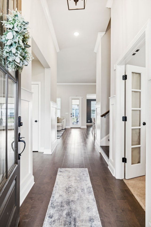 entrance foyer featuring crown molding and dark hardwood / wood-style floors