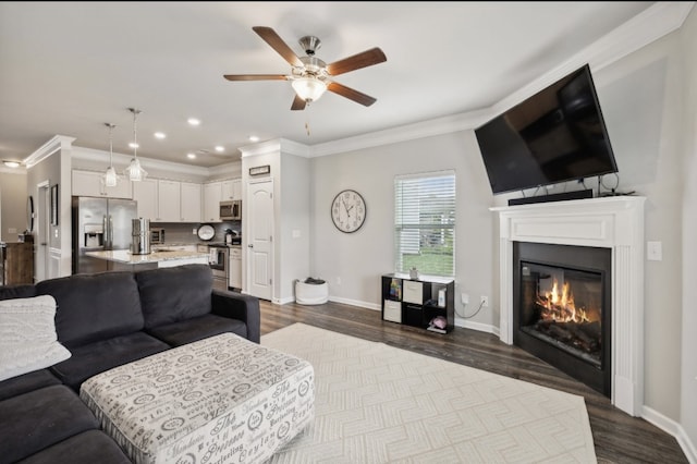 living room featuring crown molding, hardwood / wood-style flooring, and ceiling fan