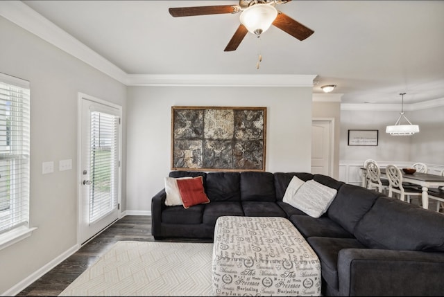 living room featuring dark hardwood / wood-style flooring, ornamental molding, ceiling fan, and a wealth of natural light