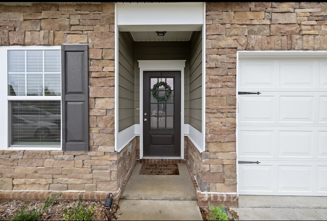 view of exterior entry with a garage