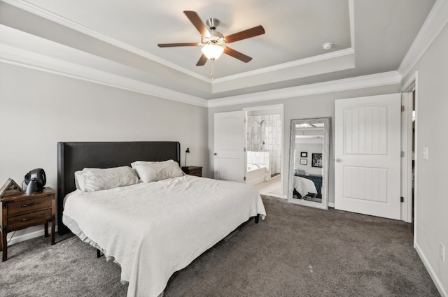 carpeted bedroom with connected bathroom, ornamental molding, a tray ceiling, and ceiling fan