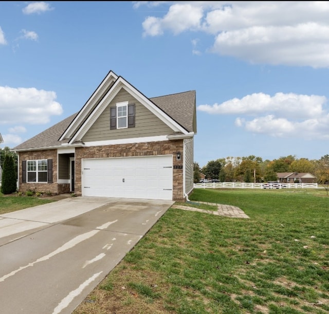 craftsman-style house featuring a garage and a front lawn