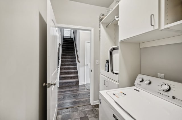 laundry room with washer / dryer, dark hardwood / wood-style floors, and cabinets