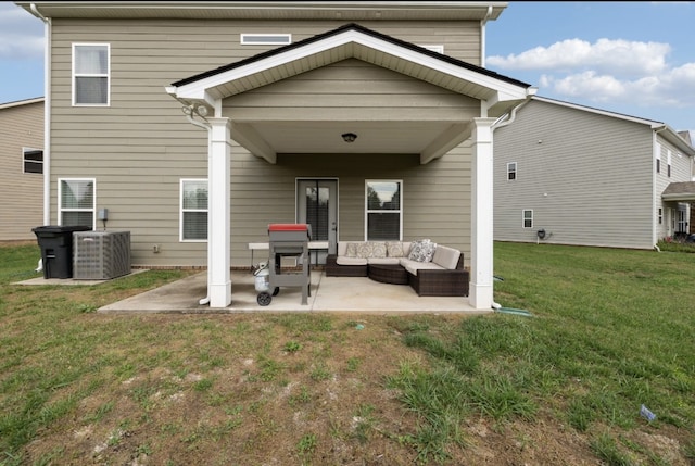 rear view of property featuring a patio, an outdoor living space, a yard, and central AC unit