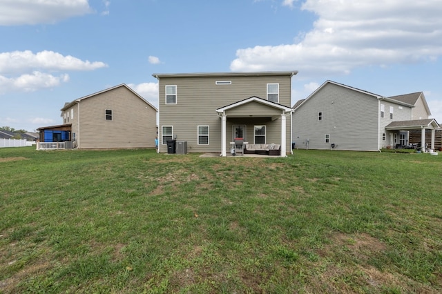 rear view of property with a yard, a patio area, and central AC unit