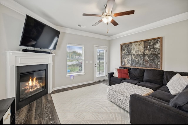 living room featuring ceiling fan, ornamental molding, and light hardwood / wood-style flooring