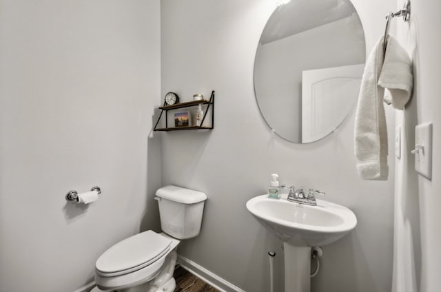 bathroom with toilet and hardwood / wood-style floors