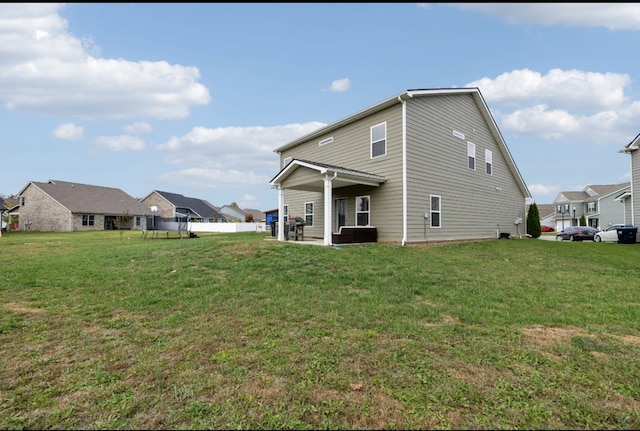 rear view of house with a lawn