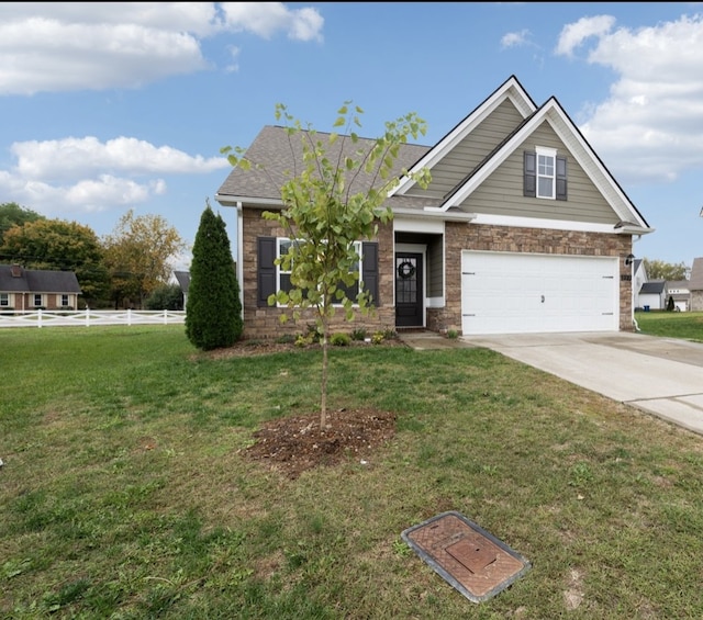 craftsman inspired home featuring a front lawn and a garage