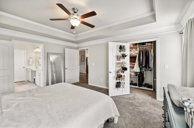 bedroom featuring a tray ceiling, a closet, ceiling fan, light carpet, and crown molding