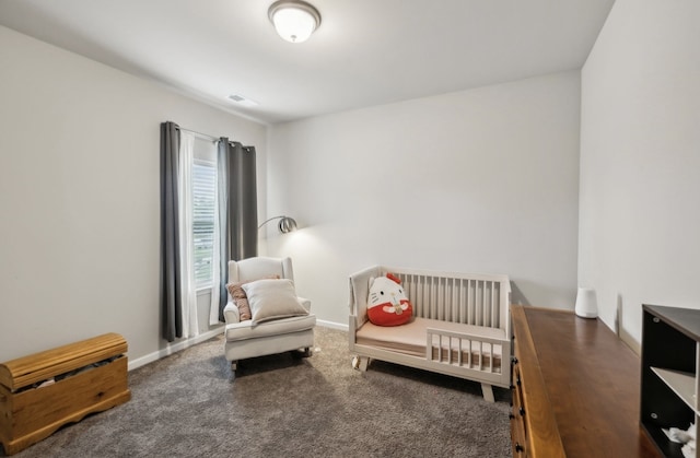 bedroom featuring dark colored carpet and a crib