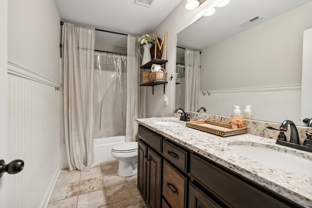 full bathroom with vanity, shower / tub combo, and toilet