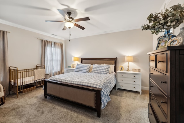 carpeted bedroom featuring ceiling fan and ornamental molding