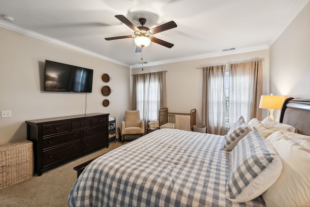 carpeted bedroom featuring multiple windows, ornamental molding, and ceiling fan