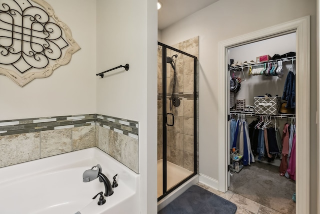 bathroom featuring shower with separate bathtub