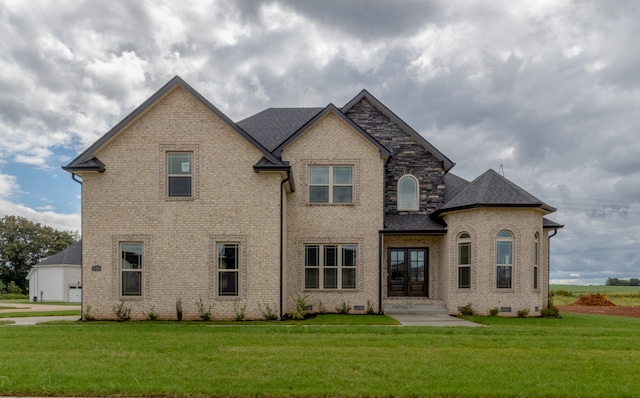 french provincial home featuring a front yard