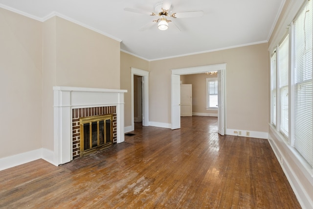 unfurnished living room with crown molding, a fireplace, dark hardwood / wood-style floors, and ceiling fan