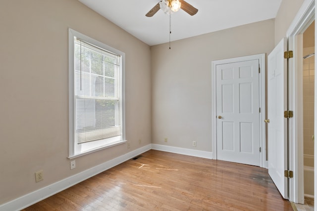 spare room with light hardwood / wood-style floors and ceiling fan