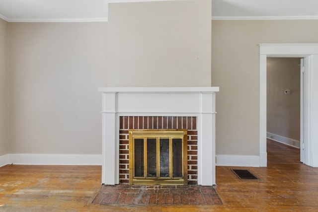 unfurnished living room featuring ornamental molding, dark wood-type flooring, and a fireplace