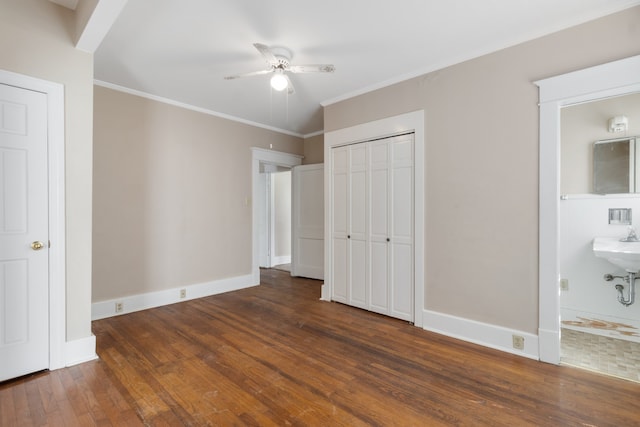 unfurnished bedroom featuring ornamental molding, ceiling fan, connected bathroom, and dark hardwood / wood-style flooring