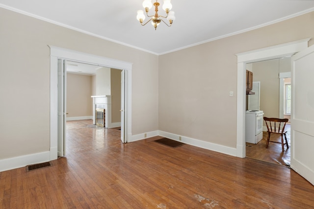 unfurnished room with crown molding, wood-type flooring, and an inviting chandelier