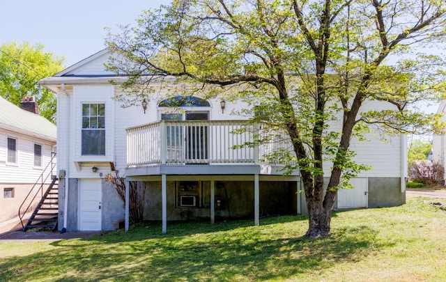 back of property featuring a wooden deck and a lawn