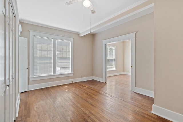 spare room featuring ceiling fan, wood-type flooring, and ornamental molding