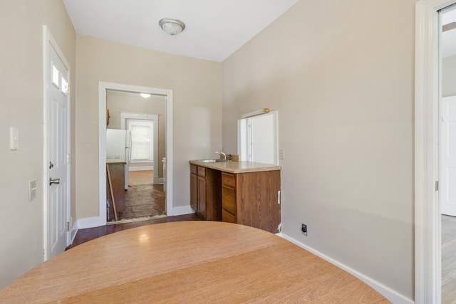 hall featuring hardwood / wood-style flooring and sink