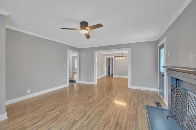 unfurnished living room with light hardwood / wood-style floors, crown molding, and ceiling fan