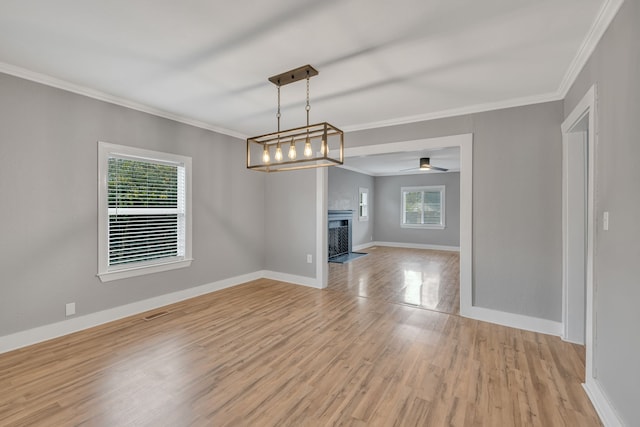 unfurnished living room with light hardwood / wood-style floors and a healthy amount of sunlight