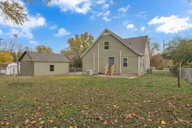 rear view of property featuring a patio, a storage unit, cooling unit, and a yard