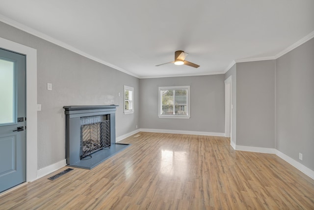 unfurnished living room with crown molding, light wood-type flooring, and ceiling fan