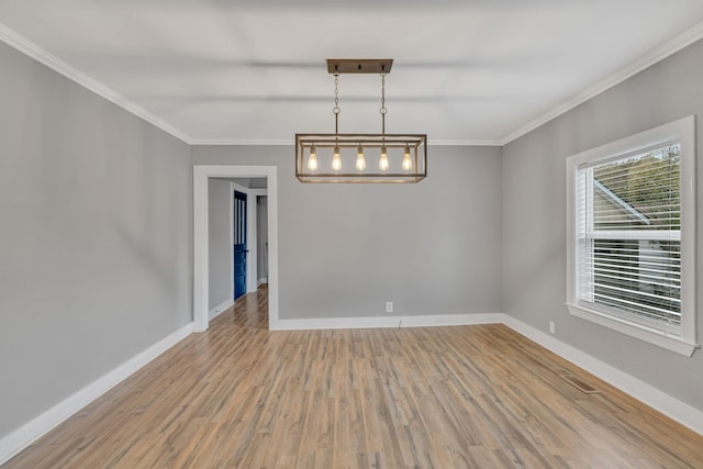 empty room with ornamental molding and wood-type flooring