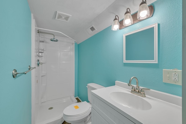 bathroom featuring vanity, toilet, and a shower