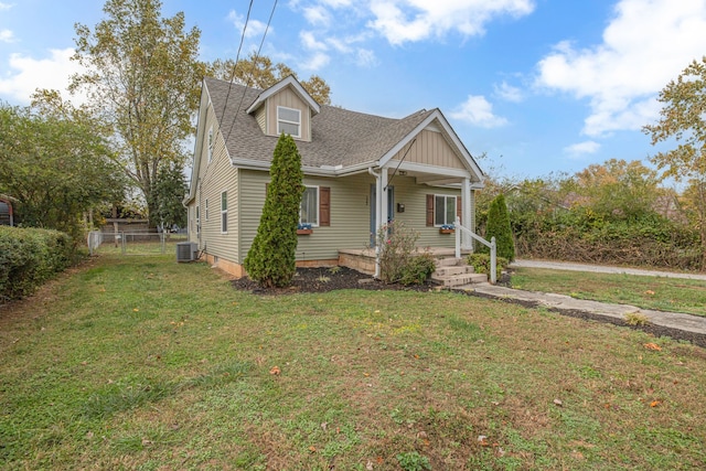 view of front of property with central AC, a front yard, and a porch