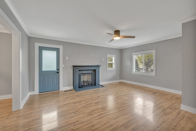 unfurnished living room featuring crown molding, light hardwood / wood-style flooring, and ceiling fan