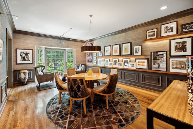 dining room featuring crown molding and light wood-type flooring