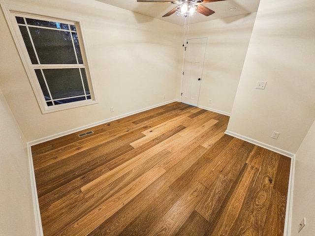 spare room with hardwood / wood-style floors and ceiling fan