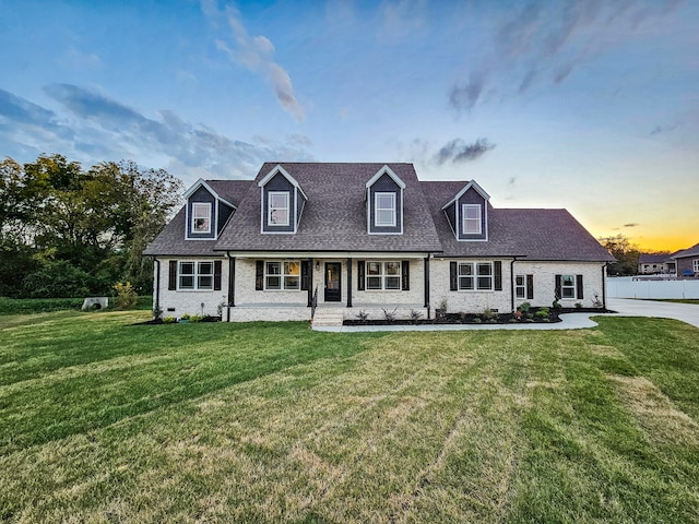 new england style home with a lawn