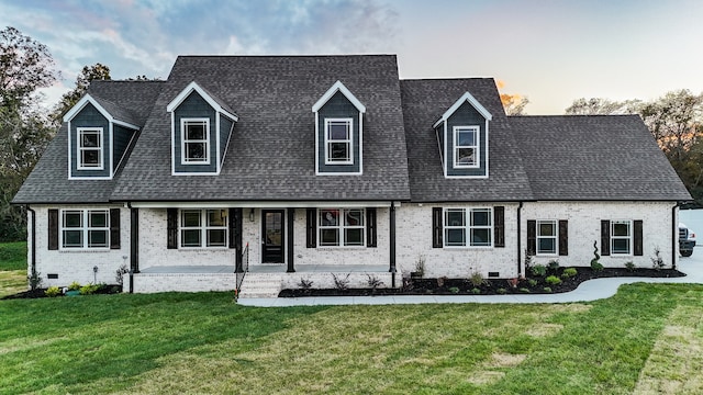 cape cod home with a yard